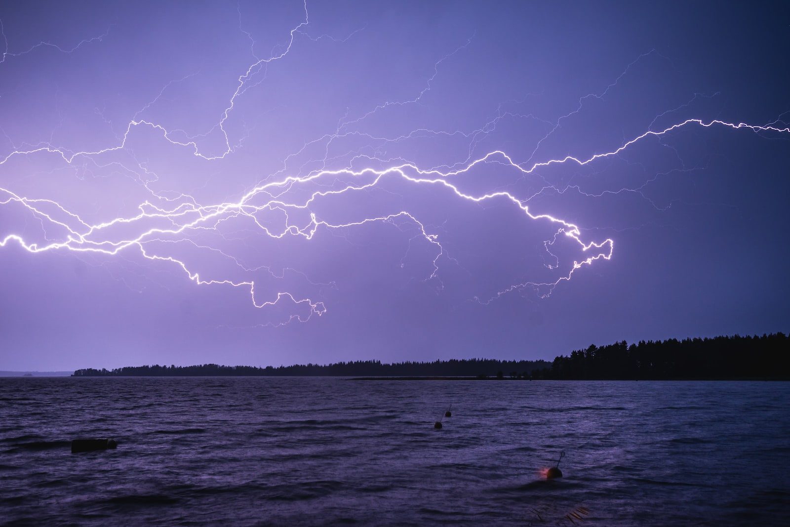 lightning above ocean during night time